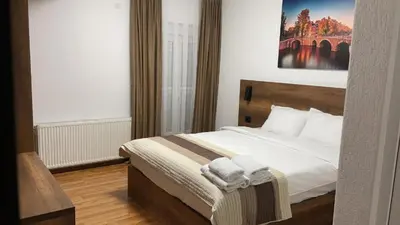 a bedroom with a large bed with towels on it at Bici Resort in Samoljica