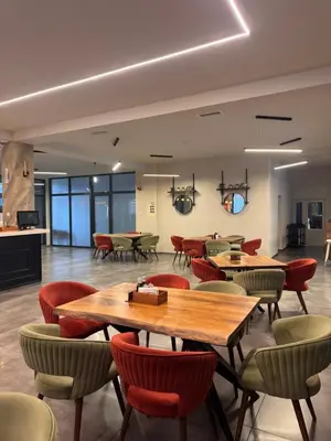 a restaurant with tables and chairs in a room at Bici Resort in Samoljica