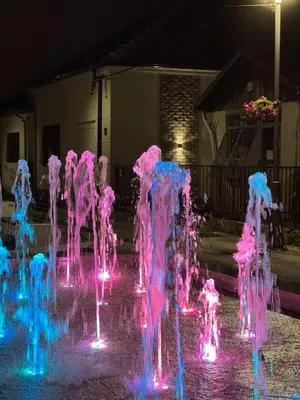 a water fountain with pink and blue lights at SQUARE apartment in Ćuprija