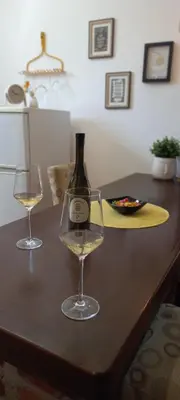 a bottle of wine and two glasses on a table at SQUARE apartment in Ćuprija