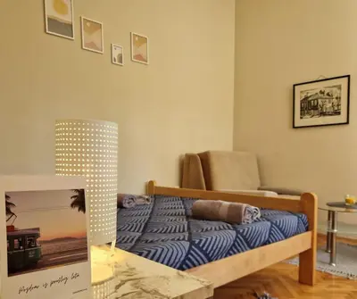 a bedroom with a bed and a chair at Apartmani Central Vrnjačka Banja Šetalište in Vrnjačka Banja