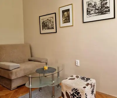 a living room with a couch and a table at Apartmani Central Vrnjačka Banja Šetalište in Vrnjačka Banja