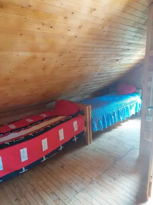 a room with bunk beds and a wooden ceiling at Drinska Ljepotica Ljubovija in Bukorovac