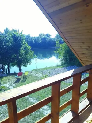 a view of a lake from the porch of a cabin at Drinska Ljepotica Ljubovija in Bukorovac