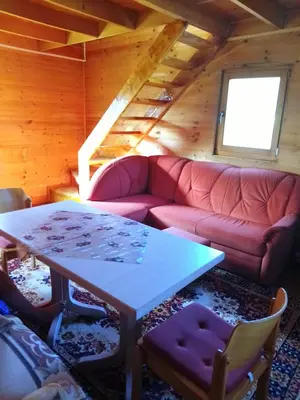 a living room with a couch and a table at Drinska Ljepotica Ljubovija in Bukorovac