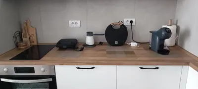 a kitchen counter with a blender and appliances on it at Planet-A1012 in Niš