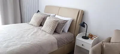a bedroom with a bed with pillows and a lamp at Planet-A1012 in Niš