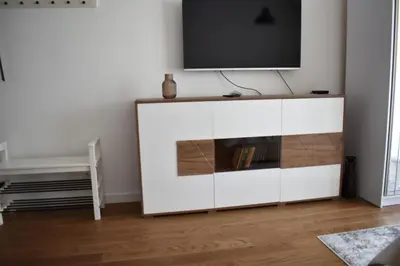 a white cabinet with a television on top of it at Planet-A1012 in Niš