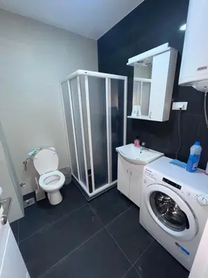 a bathroom with a washing machine and a toilet at Banjski Raj in Vrnjačka Banja