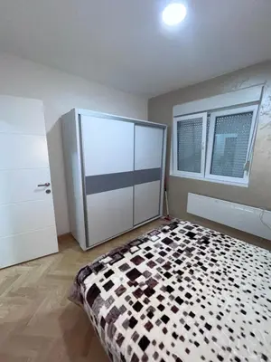 a bedroom with a black and white checkered bed at Banjski Raj in Vrnjačka Banja