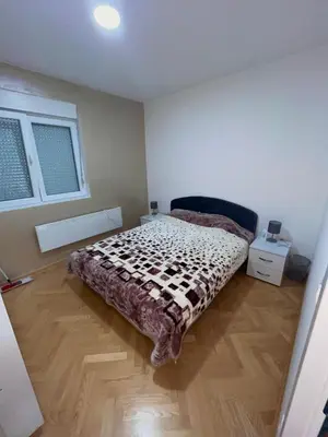 a bedroom with a bed in the corner of a room at Banjski Raj in Vrnjačka Banja