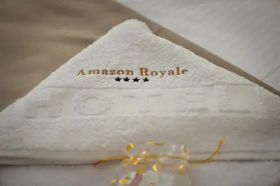 a white towel with the words american royale on it at Amazon Royale Apartment in Niš