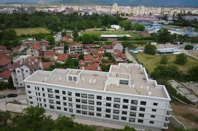 an aerial view of a white building in a city at Amazon Royale Apartment in Niš