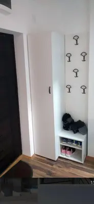a room with a white cabinet with shoes in it at Bufan apartman in Soko Banja
