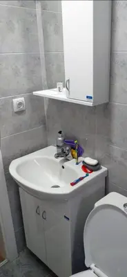 a bathroom with a white sink and a toilet at Bufan apartman in Soko Banja