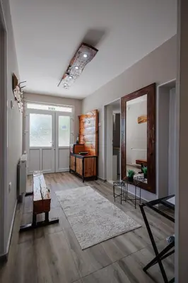 a living room with a table and a mirror at Apartman Pepa in Pirot