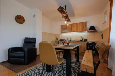 a kitchen and dining room with a table and chairs at Apartman Pepa in Pirot