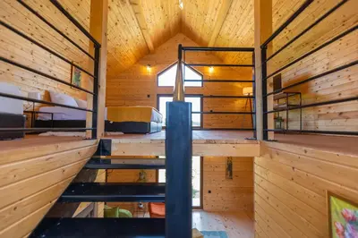 an interior view of a wooden cabin with two bunk beds at Etno selo Čubura in Čubura
