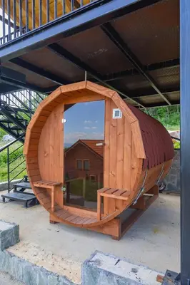 a wooden hobbit house with a mirror in it at Etno selo Čubura in Čubura
