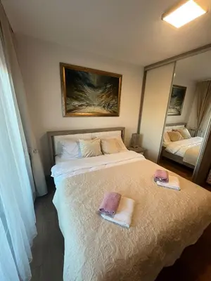 a bedroom with a bed with two towels on it at Apartman Zelena laguna in Vrnjačka Banja