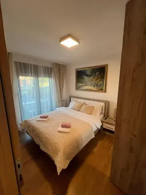 a bedroom with a bed with two towels on it at Apartman Zelena laguna in Vrnjačka Banja