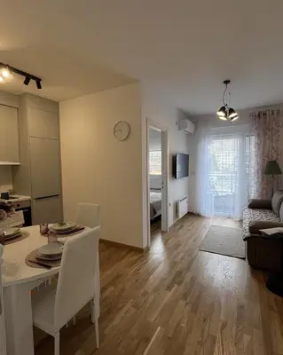 a living room with a table and a dining room at Slatina Točak in Vrnjačka Banja