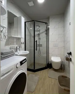 a bathroom with a shower and a washing machine at Slatina Točak in Vrnjačka Banja