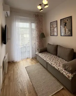 a living room with a couch in front of a window at Slatina Točak in Vrnjačka Banja