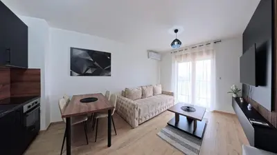a living room with a couch and a table at Apartmani Central A50 & Free Parking in Vrnjci