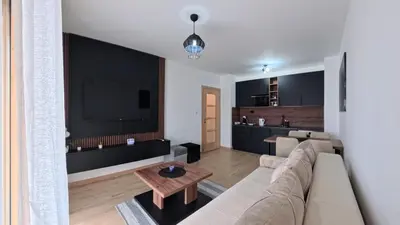a living room with a couch and a table at Apartmani Central A50 & Free Parking in Vrnjci