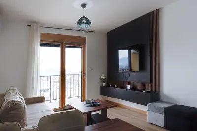 a living room with a couch and a table at Apartmani Central A50 & Free Parking in Vrnjci