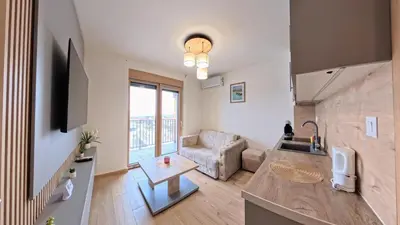 a living room with a couch and a table at Apartmani Central A50 & Free Parking in Vrnjci