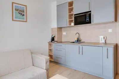 a kitchen with a couch and a sink and a microwave at Apartmani Central A50 & Free Parking in Vrnjci