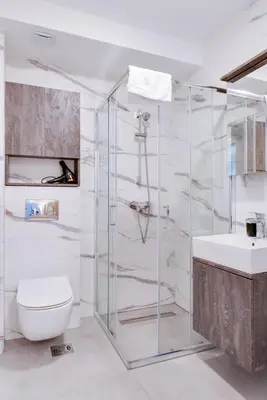 a bathroom with a shower and a toilet and a sink at Apartmani Central A50 & Free Parking in Vrnjci