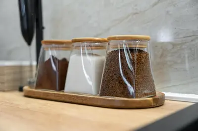 three glass containers filled with food sitting on a counter at Duma Apartmani 2 Vrnjačka Banja in Vrnjačka Banja