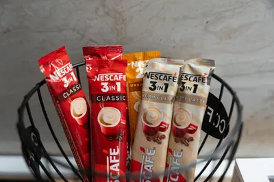 a black basket with three packets of snacks in it at Duma Apartmani 2 Vrnjačka Banja in Vrnjačka Banja