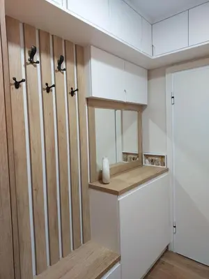 a room with a closet with white cabinets and a mirror at Duma Apartmani 2 Vrnjačka Banja in Vrnjačka Banja