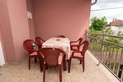 a table and chairs sitting on a balcony at Sobe Joksimović in Vrnjačka Banja