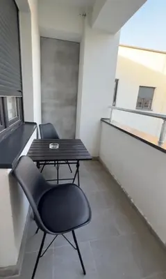 a balcony with a table and chairs in a building at apartmanjagodinaana 2 in Trnava