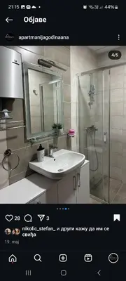 a bathroom with a sink and a shower with a mirror at apartmanjagodinaana 2 in Trnava