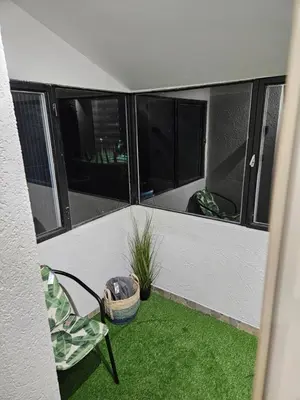an empty balcony with a chair and a plant at Apartman Tara in Soko Banja