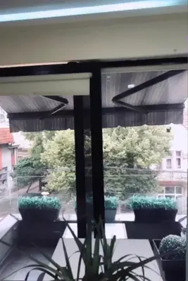 a window with a view of a patio with plants at LUCHIANO apartments in Niš