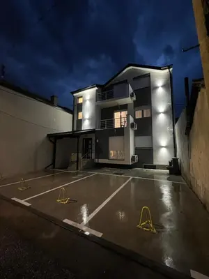 a building with a parking lot in front of it at S&M apartman FREE PARKING in Vranje