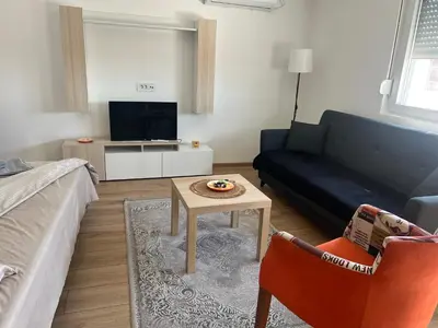 a living room with a couch and a table at S&M apartman FREE PARKING in Vranje
