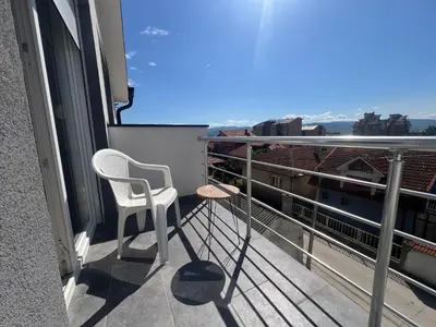 a balcony with a chair and a view of the city at S&M apartman FREE PARKING in Vranje