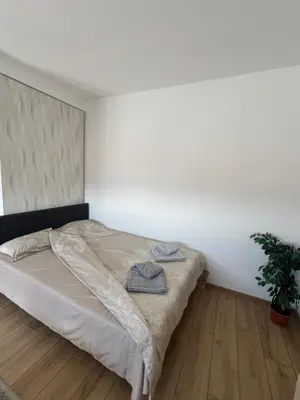a bedroom with a bed and a potted plant at S&M apartman FREE PARKING in Vranje