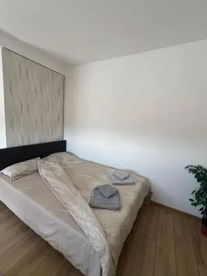 a bedroom with a bed with two towels on it at S&M apartman FREE PARKING in Vranje