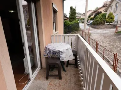 a table on the balcony of a house at Apartmani Votor in Vrnjačka Banja