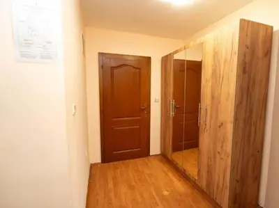 a hallway with a mirror and a wooden door at Apartmani Votor in Vrnjačka Banja