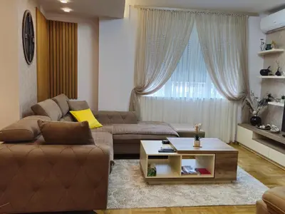 a living room with a couch and a coffee table at Gracia apartman in Vrnjci